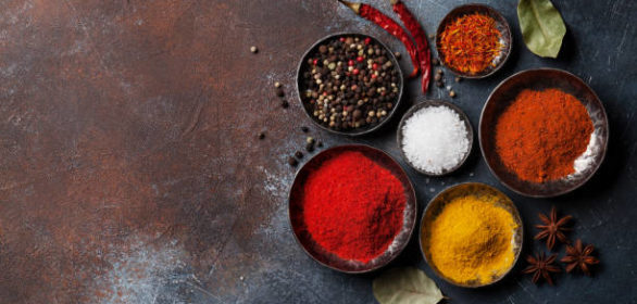 Colorful spices on stone table. Top view with space for your recipe
