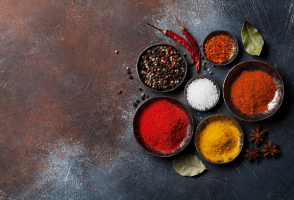 Colorful spices on stone table. Top view with space for your recipe